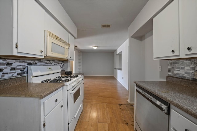 3525 Emerald Dr, Mesquite, TX 75150 - kitchen featuring white appliances, white cabinetry, tasteful backsplash, and light wood finished floors