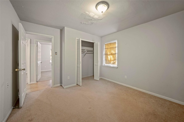 3525 Emerald Dr, Mesquite, TX 75150 - unfurnished bedroom featuring carpet flooring, a closet, and a textured ceiling
