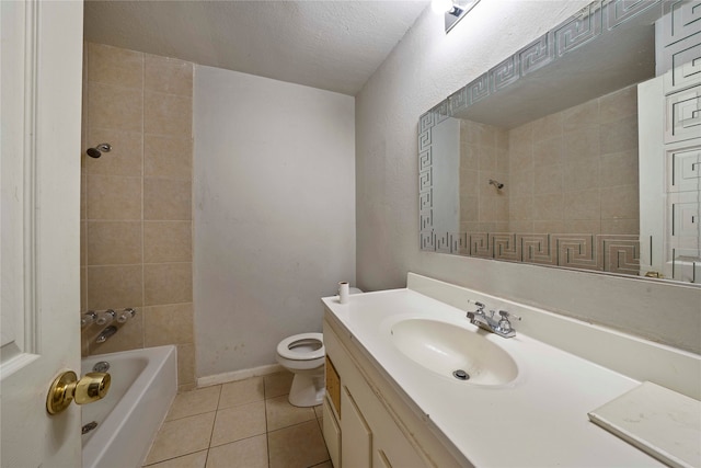 full bathroom featuring tiled shower / bath combo, tile patterned floors, a textured ceiling, toilet, and vanity