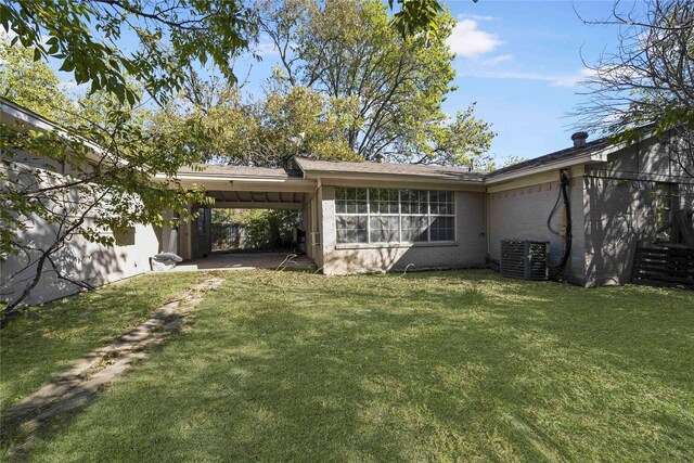 3525 Emerald Dr, Mesquite, TX 75150 - rear view of property with an attached carport and a lawn