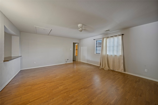 spare room featuring hardwood / wood-style flooring and ceiling fan