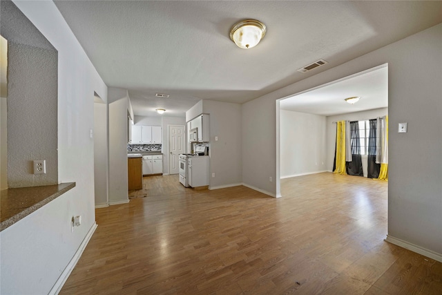 unfurnished living room featuring light hardwood / wood-style floors