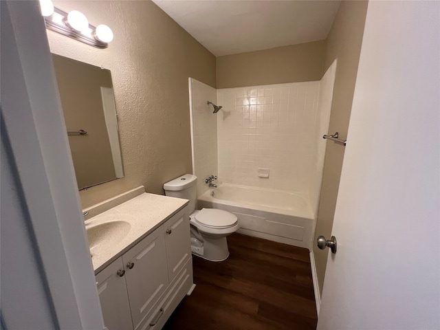 full bathroom featuring wood-type flooring, vanity, toilet, and tiled shower / bath