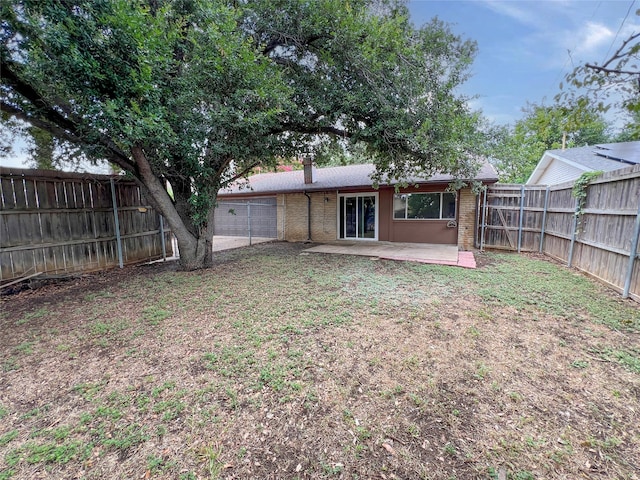 back of house featuring a yard and a patio