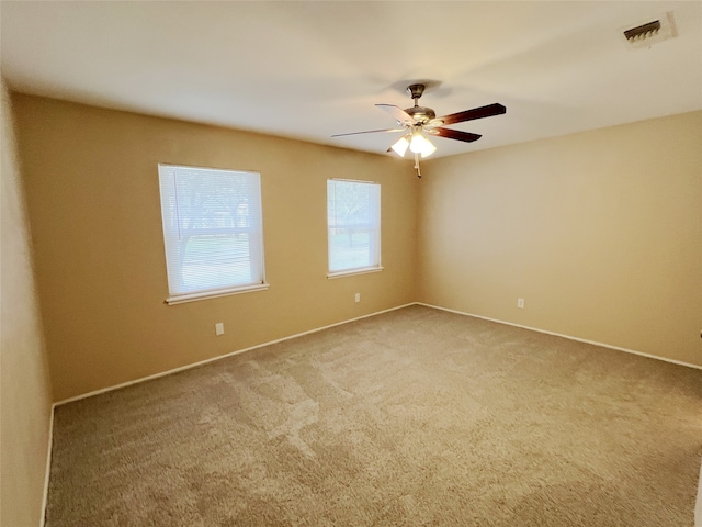 unfurnished room featuring ceiling fan and carpet floors