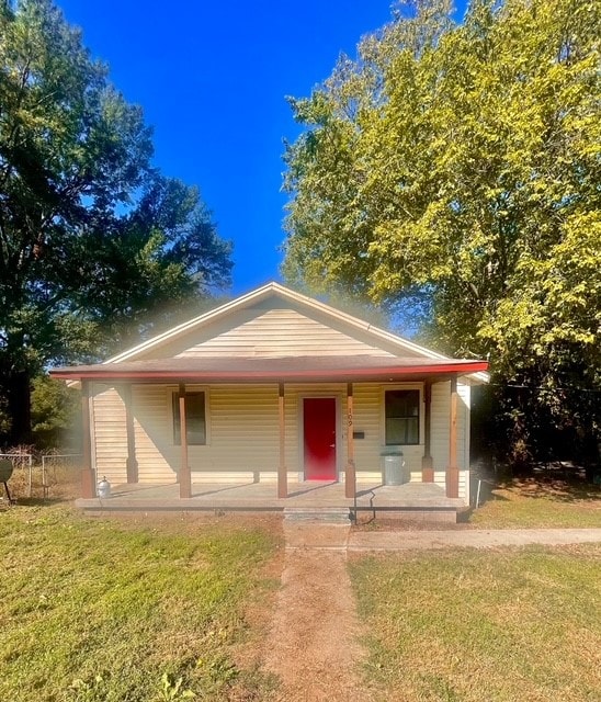 view of front of home with a front yard and covered porch