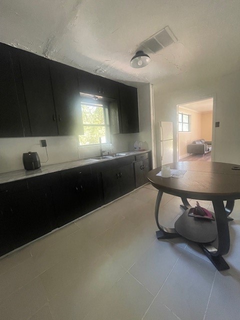 kitchen featuring light tile patterned flooring and sink