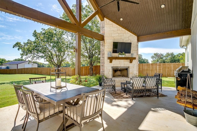 view of patio featuring grilling area and an outdoor stone fireplace