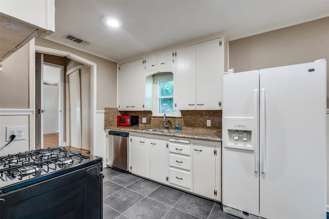 kitchen featuring black range oven, white cabinetry, dishwasher, white fridge with ice dispenser, and sink