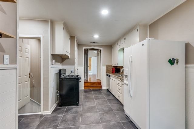 kitchen featuring white fridge with ice dispenser, sink, white cabinetry, black range oven, and stainless steel dishwasher