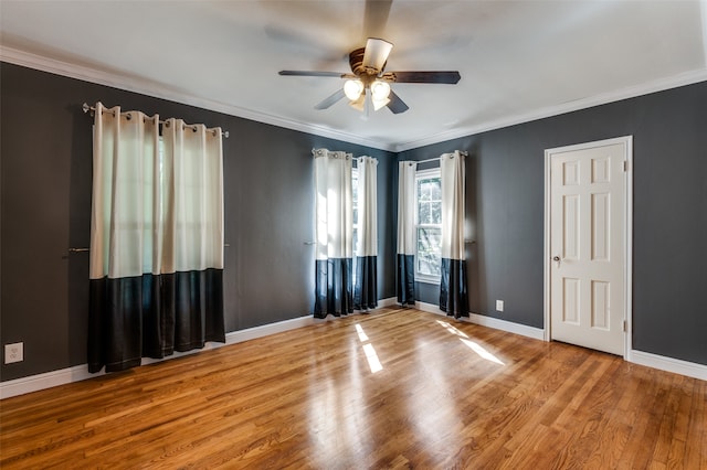 spare room with wood-type flooring, crown molding, and ceiling fan