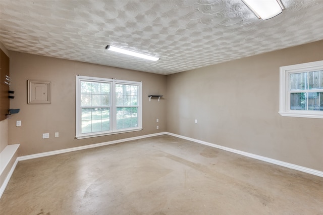 unfurnished room featuring concrete flooring