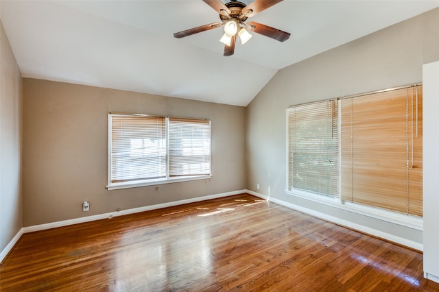 unfurnished room with ceiling fan, hardwood / wood-style flooring, and vaulted ceiling