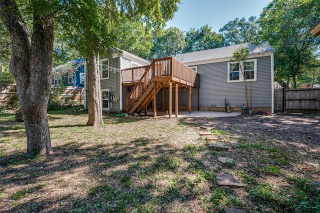 back of house featuring a patio, a deck, and a lawn