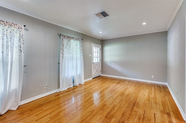 unfurnished room with crown molding and light hardwood / wood-style flooring