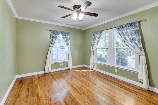 empty room featuring ceiling fan, ornamental molding, and light hardwood / wood-style floors