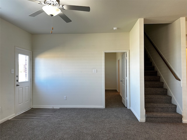 interior space featuring dark colored carpet and ceiling fan