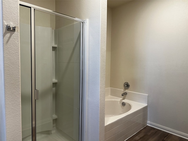 bathroom with independent shower and bath and hardwood / wood-style flooring