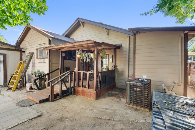 bungalow featuring central air condition unit and a patio area