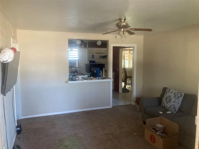 unfurnished living room featuring light carpet and ceiling fan