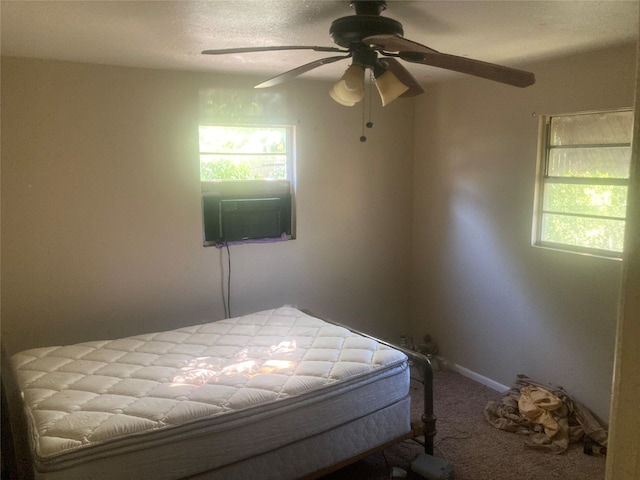 unfurnished bedroom with carpet, ceiling fan, and multiple windows