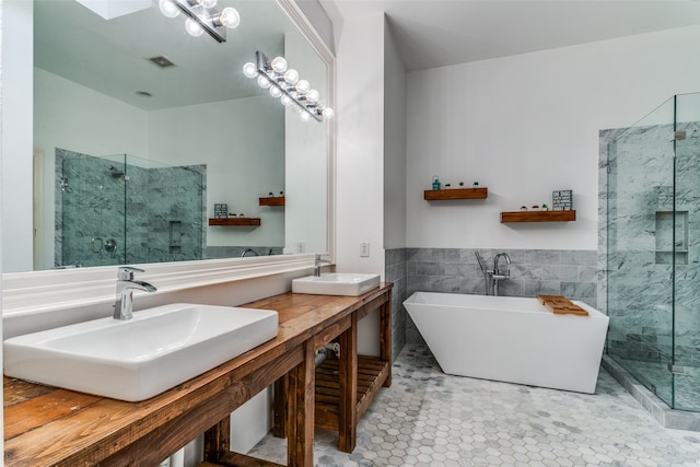 bathroom with plus walk in shower, tile walls, tile patterned floors, and vanity