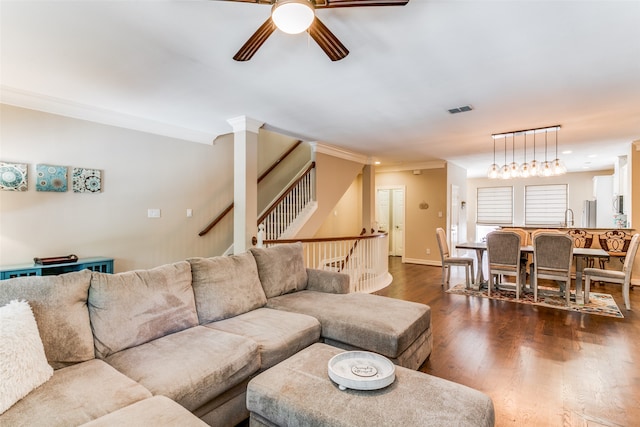 living room featuring ceiling fan, ornamental molding, sink, dark hardwood / wood-style floors, and decorative columns