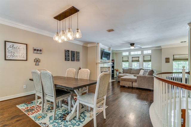 dining room with ceiling fan with notable chandelier, dark hardwood / wood-style floors, and ornamental molding