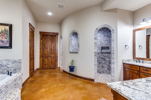 bathroom featuring concrete flooring, vanity, and separate shower and tub