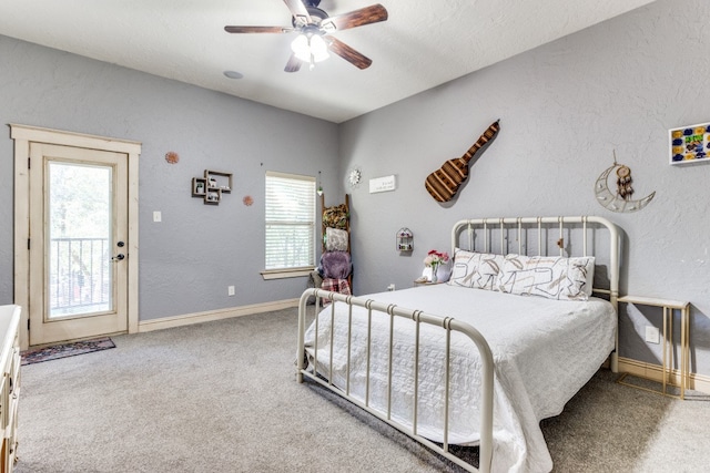 bedroom featuring ceiling fan, carpet floors, and a textured ceiling