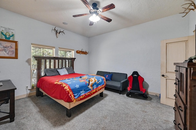 carpeted bedroom with ceiling fan and a textured ceiling