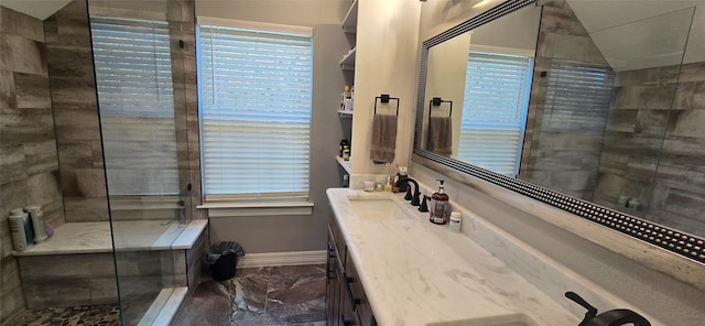 bathroom featuring an enclosed shower and vanity