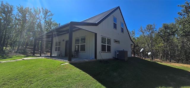 view of property exterior with a yard and central air condition unit