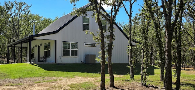 exterior space with a lawn and cooling unit