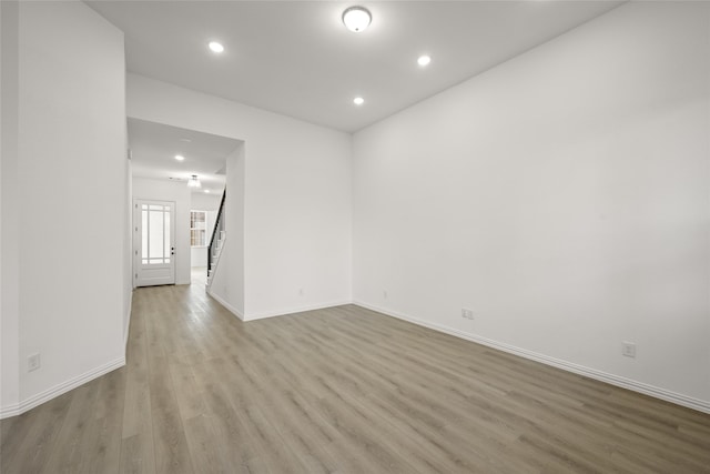 unfurnished bedroom with ensuite bathroom and light colored carpet