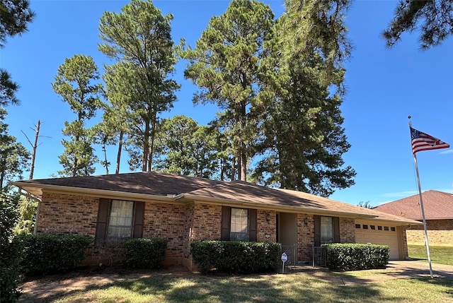 ranch-style home with a front yard and a garage