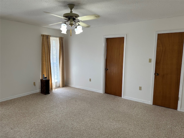 carpeted empty room featuring a textured ceiling and ceiling fan