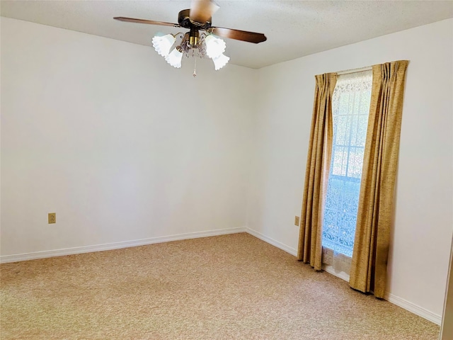 empty room featuring ceiling fan and carpet flooring