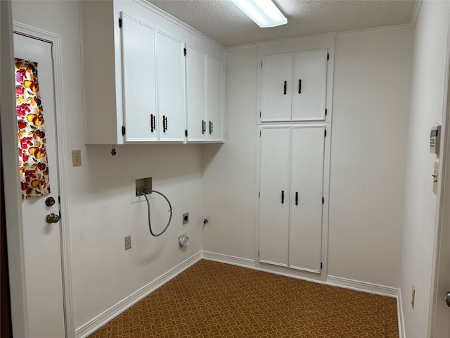 laundry room with hookup for a washing machine, hookup for an electric dryer, a textured ceiling, hookup for a gas dryer, and cabinets