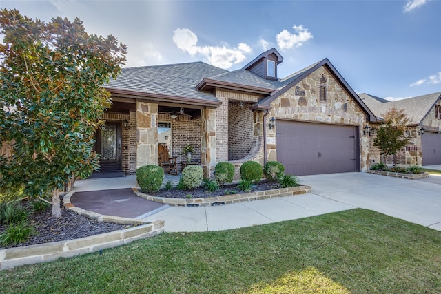 view of front facade featuring an attached garage, brick siding, concrete driveway, stone siding, and roof with shingles