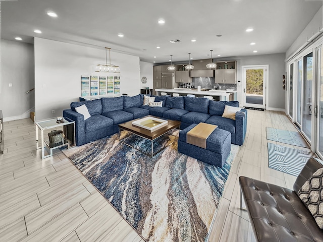 living room featuring light hardwood / wood-style flooring and a notable chandelier