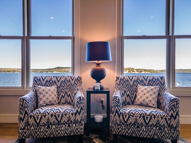 living area with a water view and hardwood / wood-style floors