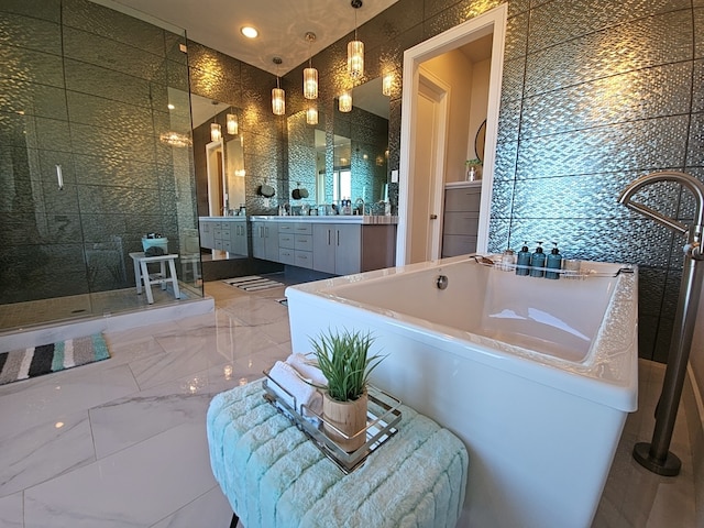 bathroom featuring tile walls, independent shower and bath, and vanity