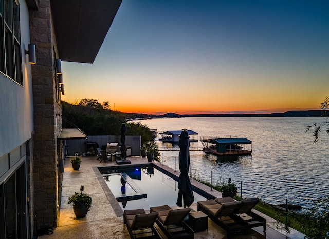 exterior space featuring a water view and a patio area