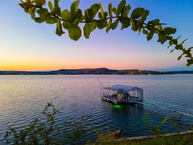 property view of water featuring a boat dock and a mountain view