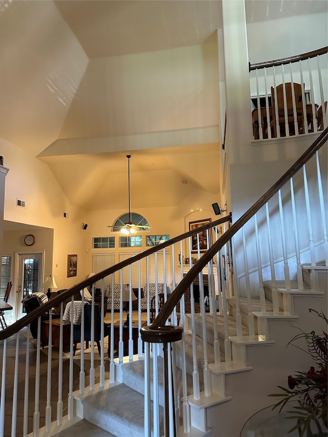 stairway with high vaulted ceiling