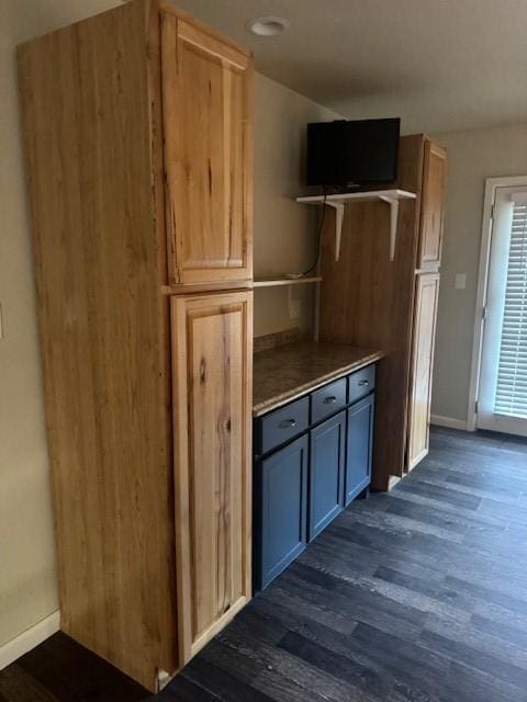 kitchen with gray cabinetry, light brown cabinets, and dark hardwood / wood-style flooring