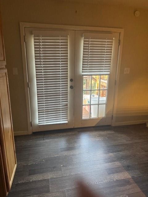 doorway with dark hardwood / wood-style floors and french doors