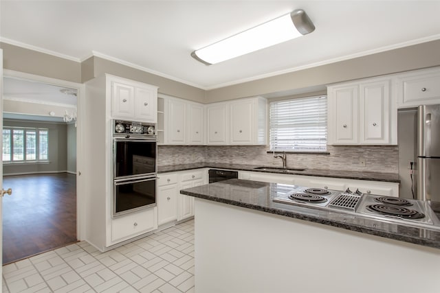 kitchen with black appliances, white cabinetry, plenty of natural light, and sink