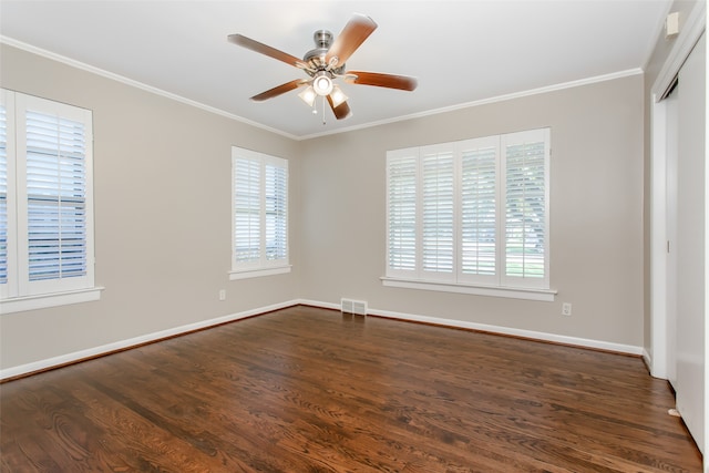 spare room with ceiling fan, dark hardwood / wood-style floors, a healthy amount of sunlight, and crown molding